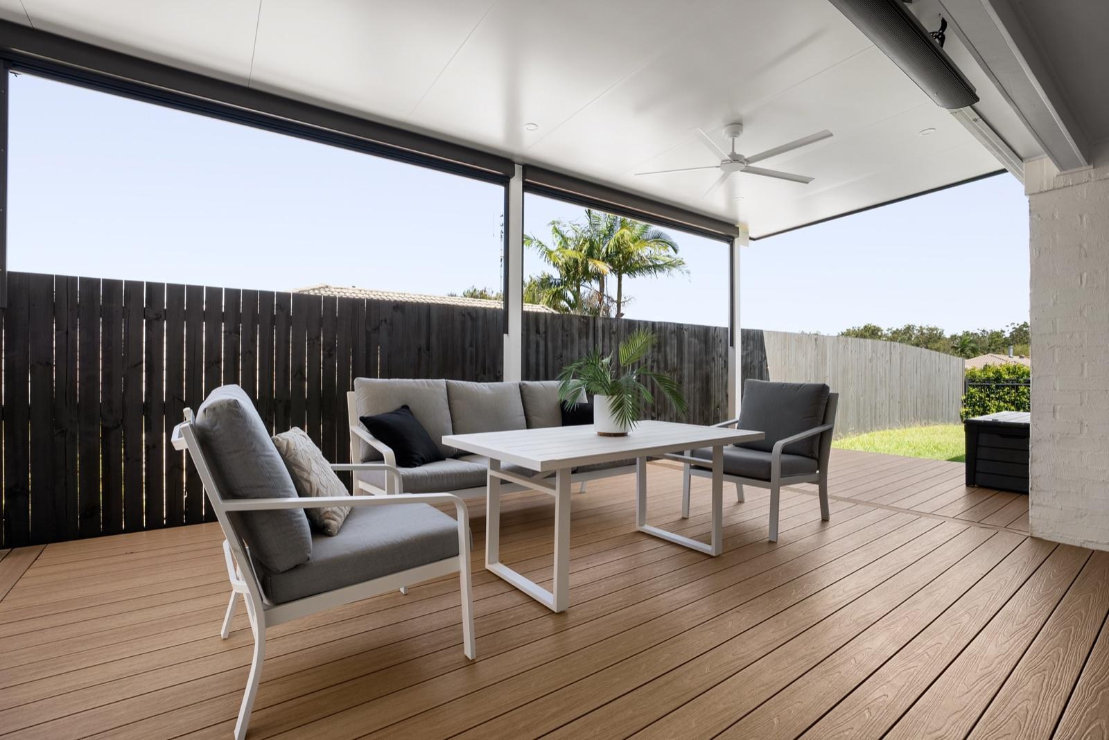 Composite deck patio with ceiling fan and cafe blinds