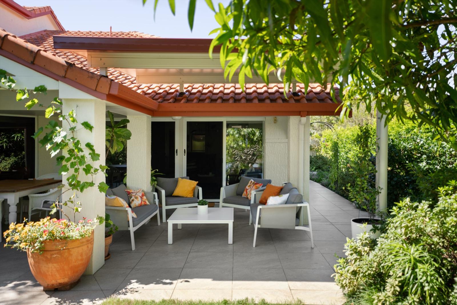 Verandah extension matching a tiled-roof rendered home